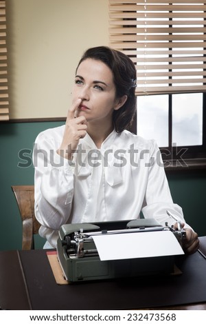Pensive vintage woman with hand on chin, typing on typewriter and looking for inspiration