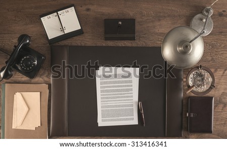 1950s style office with a contract and a pen, top view
