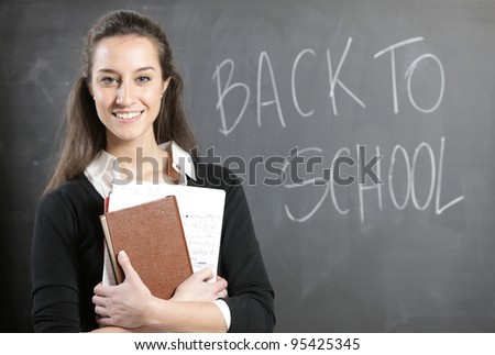 back to school: Portrait of a young woman, or teacher in front of a blackboard
