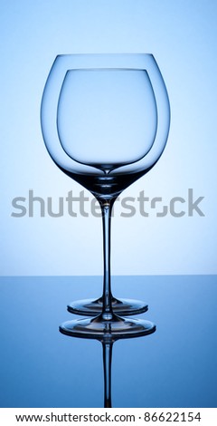 glass inside glass on blue background