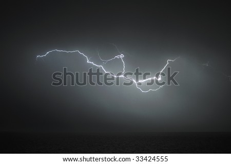 Powerful lightning during thunderstorm over the sea