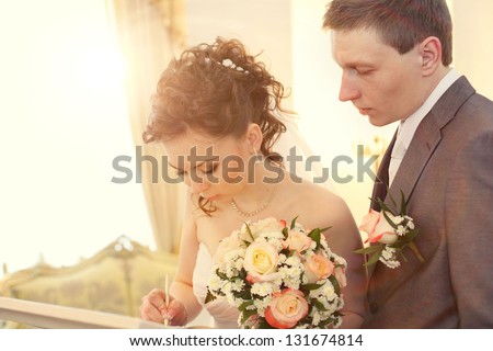 Bride signing marriage license or wedding