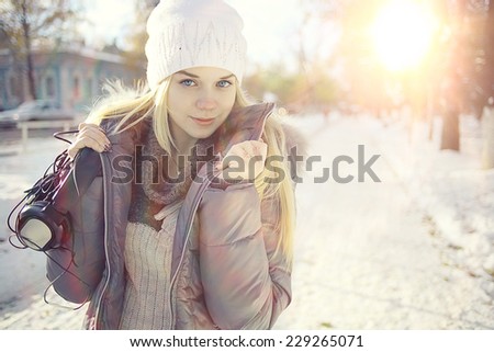 Winter portrait of young girl with headphones music
