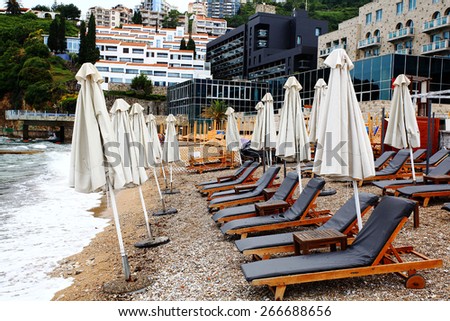 Beach umbrellas at the hotel lounge chairs