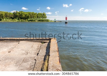 AN OLD CONCRETE PIER IN THE CHANNEL