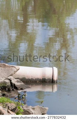 sewage pipe polluting the water
