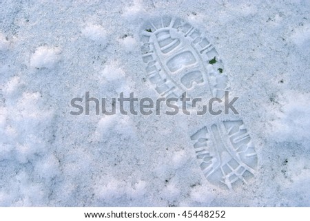 footprint of hike-boot on blue ice