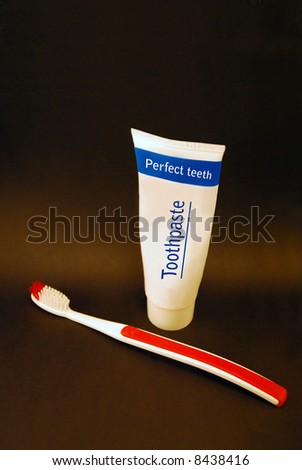 Photo of toothpaste tube and a toothbrush.