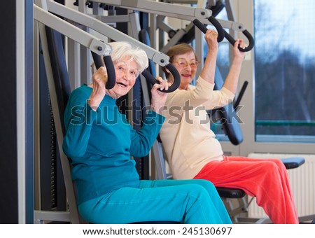 Happy Healthy Old Women Exercising at the Fitness Gym, Looking at the Camera.