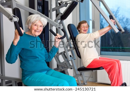 Happy Elderly Women Working Out at the Fitness Gym While Looking at the Camera.
