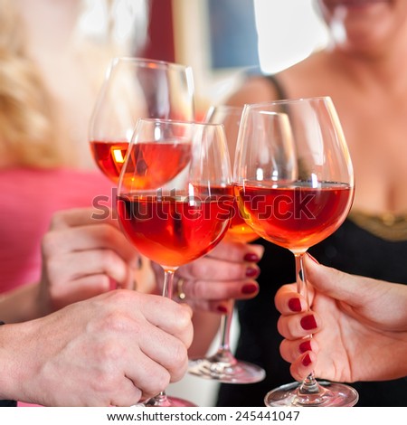 Macro Shot of Hands Raising Glasses of Tasty Red Wine in a Social Gathering.