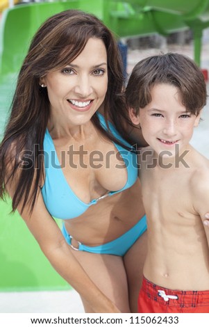 A happy family of mother and son, woman and boy child, having fun on vacation at a water park