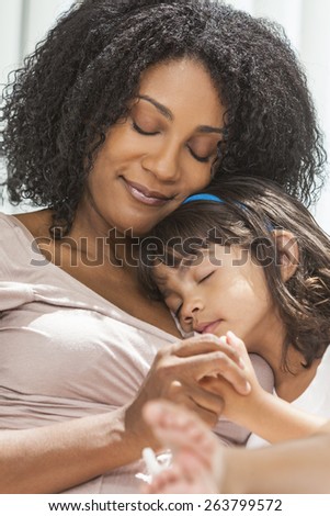 Portrait of a beautiful middle aged African American woman at home relaxing resting sleeping with her female child daughter