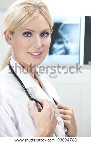 A blond female medical doctor with x-rays in a hospital