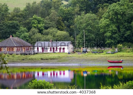 A peaceful riverside scene with strong reflections on the river