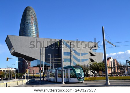 BARCELONA, SPAIN - DECEMBER 28: Modern tram in Barcelona near Agbar Tower, Spain on December 28, 2014. It is an ecological way to visit Barcelona.