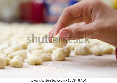 Closeup of hand making traditional homemade italian gnocchi pasta