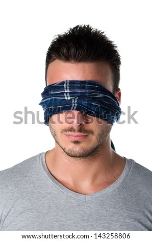 Handsome blindfolded young man with eyes covered. Concept of confusion, problem, challenge, losing your way
