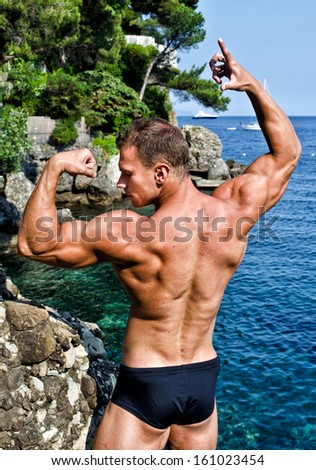 Muscular young bodybuilder outdoors