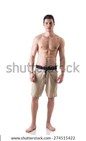 Full figure shot of handsome shirtless young man wearing stylish half shorts, isolated on white