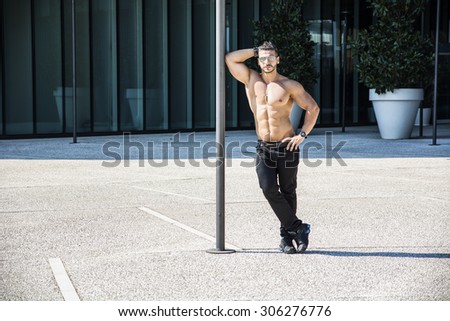 Handsome Muscular Shirtless Hunk Man Outdoor in City Setting. Showing Healthy Body While Looking At Camera