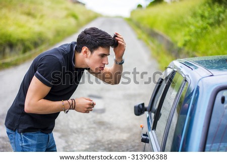 Half Body Shot of a Handsome Young Man Looking at His Reflection on a Car Window and Fixing his Hair.
