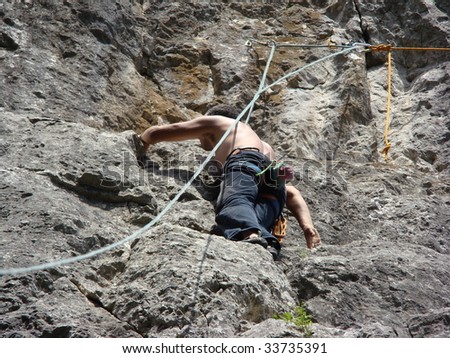 Man climbing the rock face of a mountain