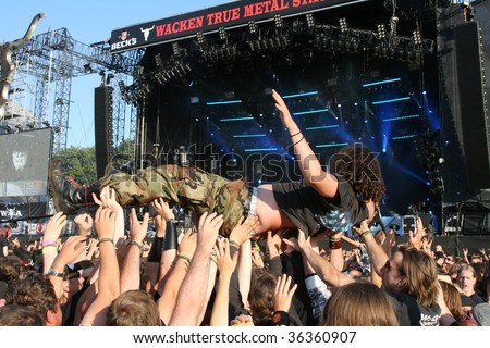 SCHLESWIG-HOLSTEIN, GERMANY - JULY 31: Crowd of people and stage diving at Wacken Open Air, world\'s largest open air heavy metal music festival on July 31, 2009, in Schleswig-Holstein, Germany