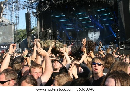 SCHLESWIG-HOLSTEIN, GERMANY - JULY 31: Crowd of people and stage diving at Wacken Open Air, world\'s largest open air heavy metal music festival on July 31, 2009, in Schleswig-Holstein, Germany