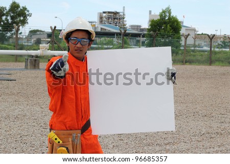 Angry oil and gas asian worker with blank sign, ready for your text.