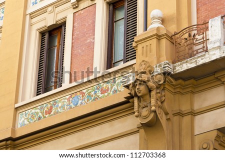 House facade with mosaic tile and beautiful relief in Florence - Italy