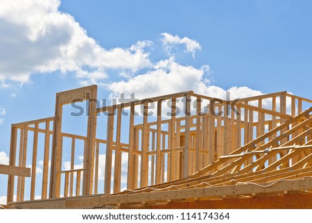 New residential construction house framing against a blue sky. Door to your dream home.