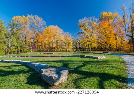 Amphitheatre in autumn park on sunny day with funny shadow from a tree. Bernheim Arboretum and Research Forest near Louisville, Kentucky, USA