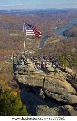 NORTH CAROLINA - NOVEMBER 23:  American flag on top of Chimney rock  on November 23, 2007 in North Caroline. Chimney Rock, a 315-foot (96 m) granite monolith in Chimney Rock State Park, North Carolina