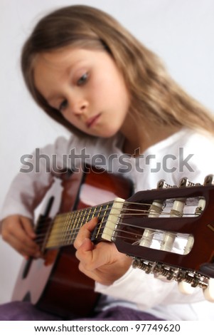 Girl is playing a guitar/music/guitar