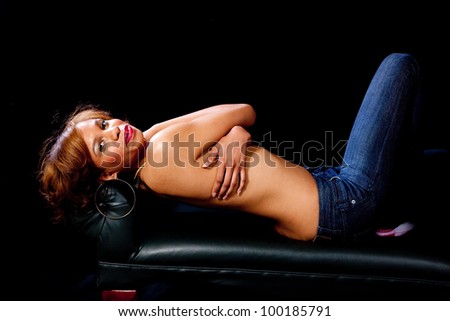 Lovely woman laying on her back and looking at the camera while covering herself