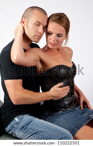 Romantic couple making out as he kisses her cheek and neck
