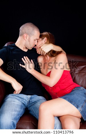 Romantic couple making out on the couch,