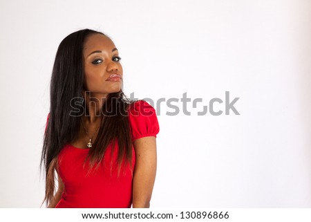 Beautiful black woman wearing a red blouse   standing and looking at the camera with a friendly expression