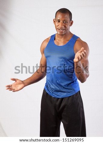 Muscular black man in blue tank top, looking at the camera with a question of why or not understanding