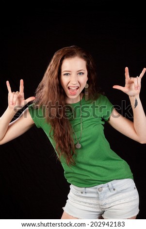 Pretty woman in green blouse, with long hair, holding her hands up and yelling playfully