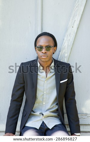 Handsome black man in sunglasses and suit coat