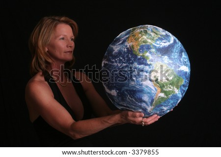 Beautiful, mature woman holding the world in her hands