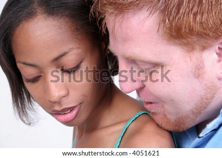 Mixed couple snuggle together with him behind her