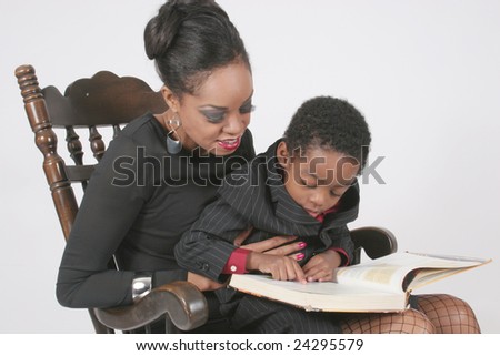 Mother reading with her son in a rocking chair