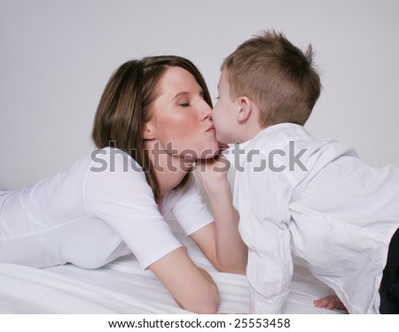 Mother and son kissing
