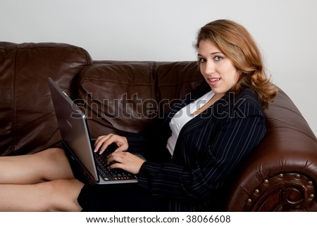 Businesswoman on couch with a laptop