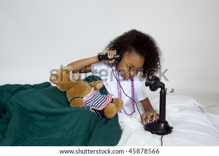 African american girl talking on old phone in bed