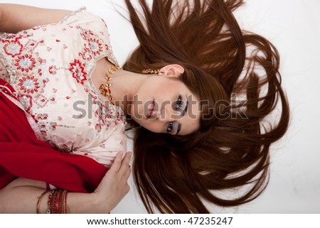 Lovely Indian woman laying on floor
