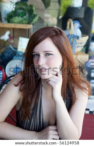 Pretty woman thinking in front of store window